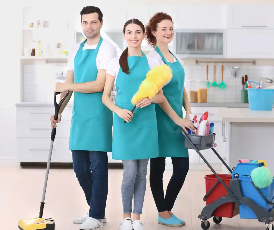 Three professional cleaners standing together after a deep house cleaning service in Miami by Clean Couture LLC.